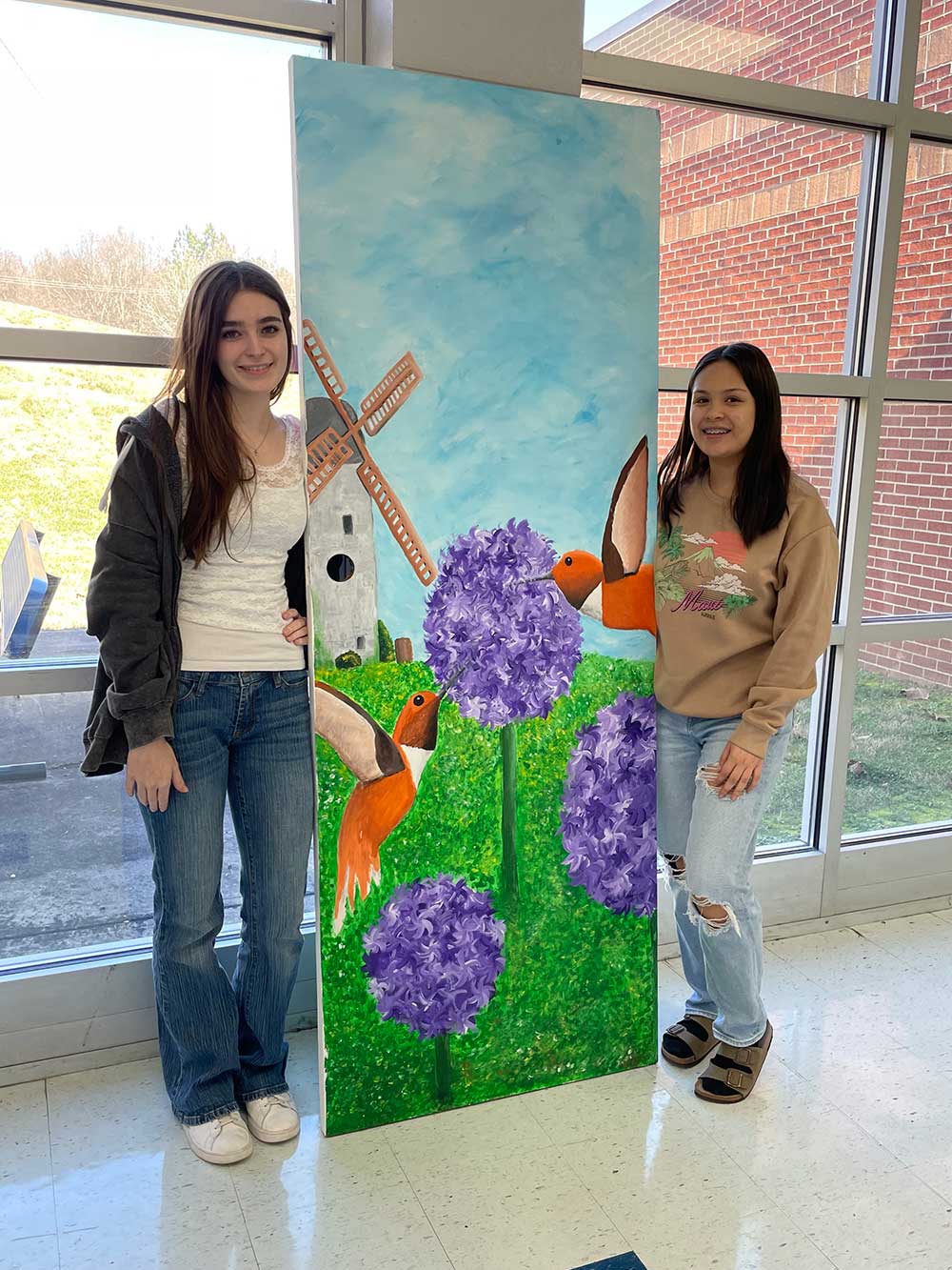 Art Students with painted door for “Opening Doorways to Spring” Exhibit